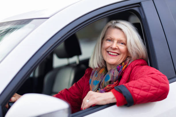 istock A senior woman enjoying her car 1206057935
