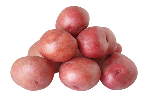 Pile of red potatoes isolated on white background