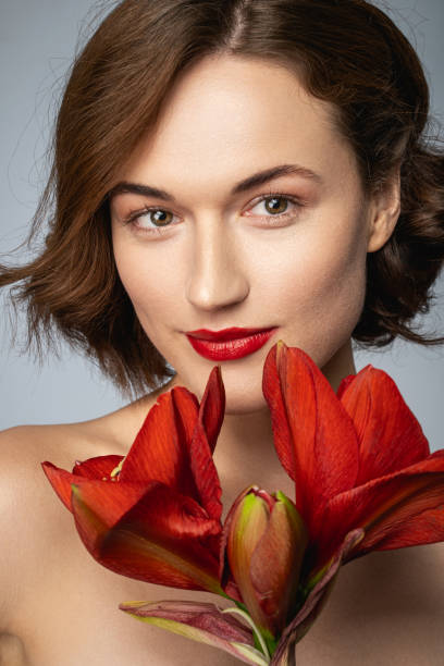 istock Attractive young female colored her lips in red 1206060489