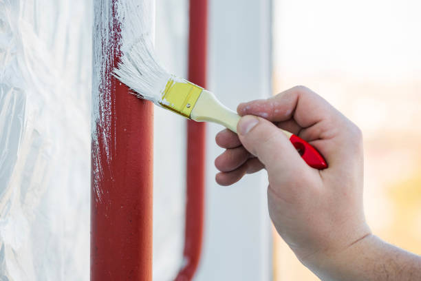istock Worker's hand with brush that painting metal construction or pipes. 1206064964