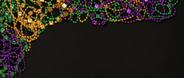 istock Purple, Gold, and Green Mardi Gras beads background 1206066914