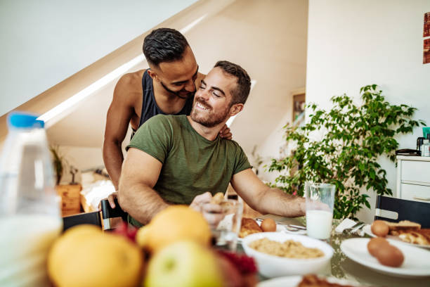 istock Gay couple at home eating breakfast and talking 1206067534