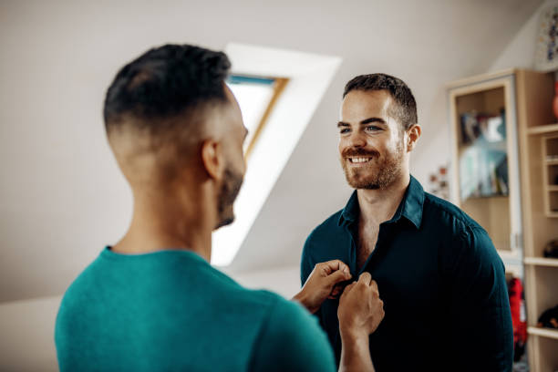 istock LGBT couple at home dressing up for work 1206068279