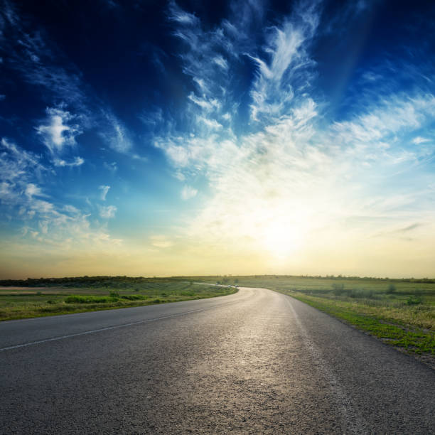 istock sunset in deep blue sky over asphalt road 1206068313