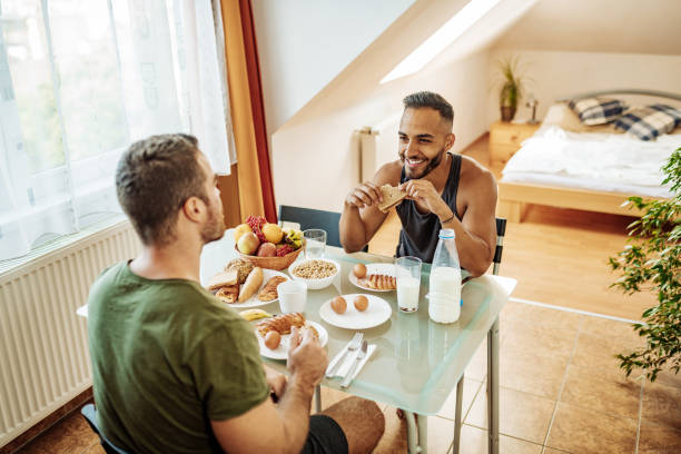 istock Gay couple at home eating breakfast and talking 1206068715