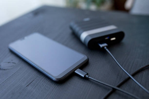 istock Powerbank and cellphone on wooden table 1206071004