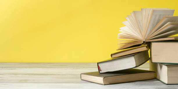 istock Open book, hardback books on wooden table. Back to school. Copy space. 1206072200