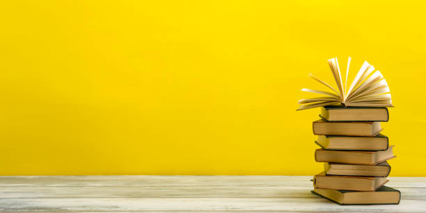 Open book, hardback books on wooden table. Back to school. Copy space.
