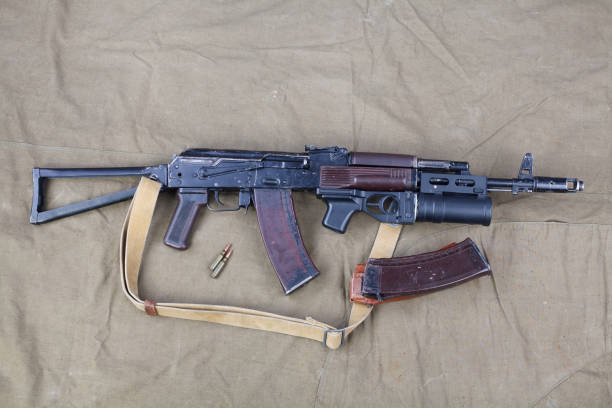 istock Kalashnikov AK 74 with underbarrel grenade launcher and ammunitions on canvas 1206072620