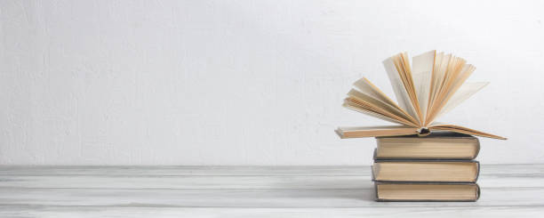 istock Open book, hardback books on wooden table. Back to school. Copy space. 1206072646