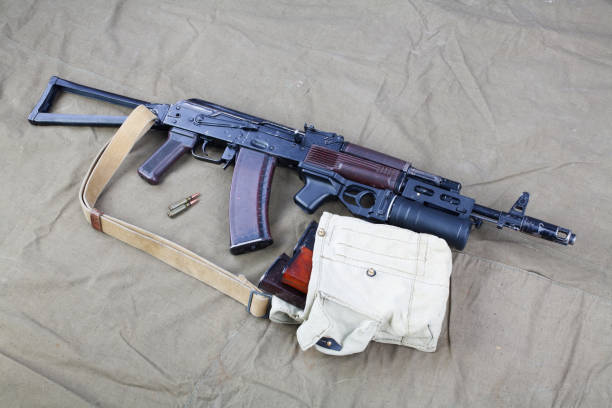 istock Kalashnikov AK 74 with underbarrel grenade launcher and ammunitions on canvas 1206073003