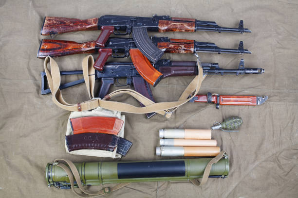 several ak 47 on canvas with ammunitions on canvas several ak 47 on canvas with ammunitions on canvas background ak 47 violence industry black stock pictures, royalty-free photos & images