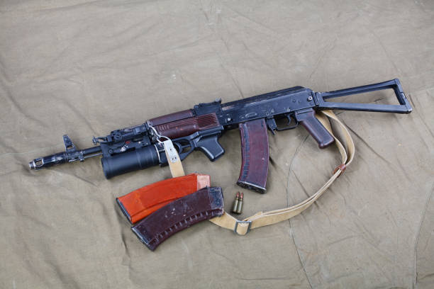 istock Kalashnikov AK 74 with underbarrel grenade launcher and ammunitions on canvas 1206073061