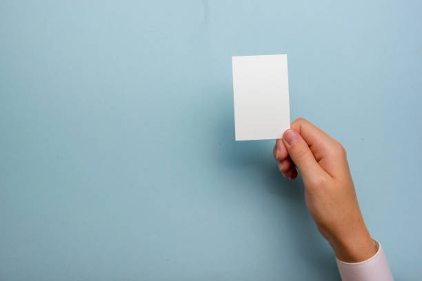 istock Hand holding white business card on white background 1206073081