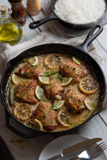 istock lemon butter chicken in iron skillet with cooked rice 1206073697