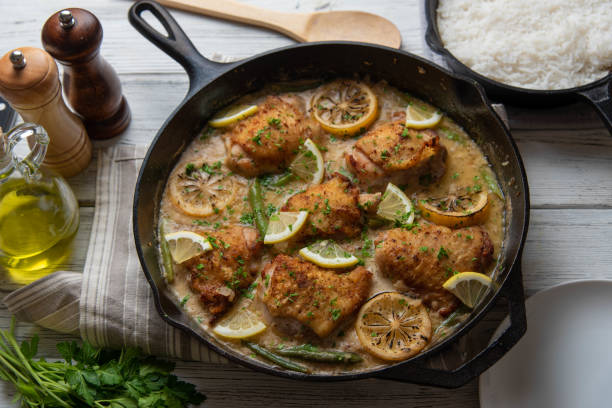 istock lemon butter chicken in iron skillet with cooked rice 1206073722