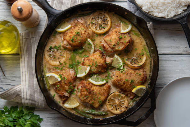 istock lemon butter chicken in iron skillet with cooked rice 1206073810
