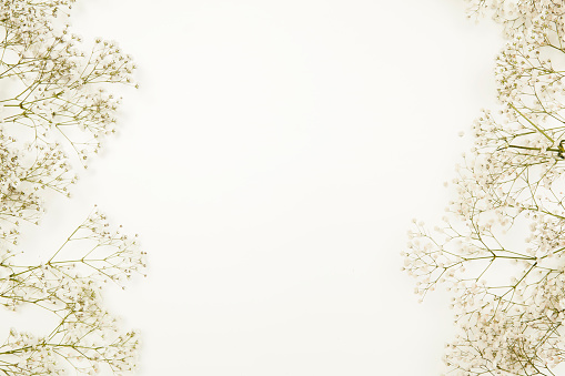 Wedding flower frame on blue table from above. Flat lay style.