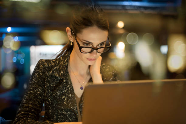 istock Night work woman glass reflections 1206079220