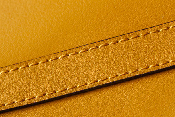 Detail of handbag with stitching, genuine leather of bright yellow color. Texture and fashionable background, copy space Detail of handbag with stitching, genuine leather of bright yellow color. Texture and fashionable modern background, copy space leather clasp stock pictures, royalty-free photos & images