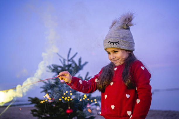 istock Playful child celebrating a new year outdoors on the beach 1206082715