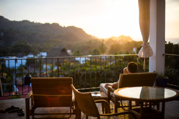 istock Man relaxing on balcony with a view on the jungle, Nayarit, Mexico 1206085361