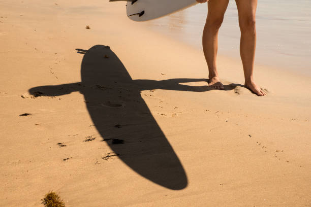 istock Young woman walking with surfboard at Surfside Beach, Texas 1206085768