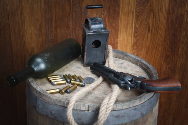 istock Old western revolver with cartridges and silver dollar 1206086429