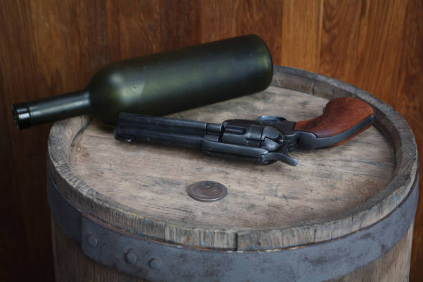 istock Old western revolver with cartridges and silver dollar 1206086510