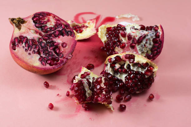 istock Pomegranate cut with knife. One half is broken into pieces 1206086532