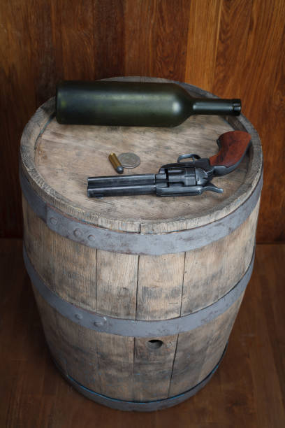 istock Old western revolver with cartridges and silver dollar 1206086556