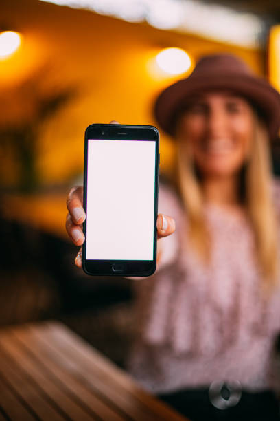 istock Young Woman Showing Smartphone Screen 1206087759