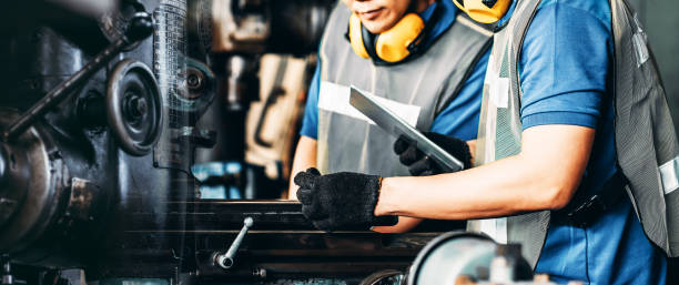 istock image motion engineer working at industrial machinery in factory. Manual workers cooperating while a machinery. 1206088424