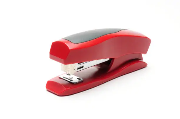 Red office stapler on an isolated white background