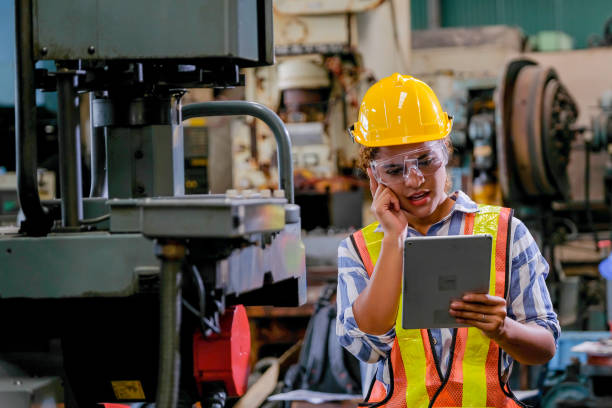 istock Technician woman with tablet check or maintenance the machine in factory 1206094807