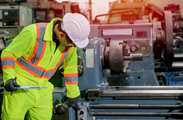 istock Technician man with safety uniform check and maintenance the machine in factory 1206094859