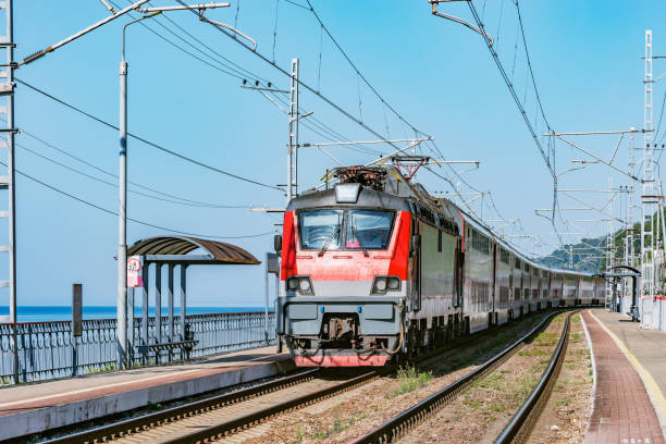istock Passenger double deck train moves along the platform and Black sea shore. Sochi. 1206097293
