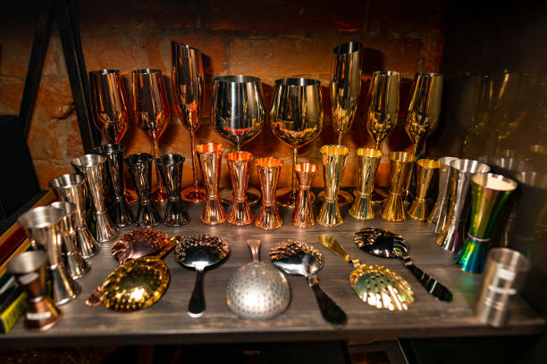 istock Professional bartender equipment as different metal color jiggers, glasses and strainer spoon 1206098324