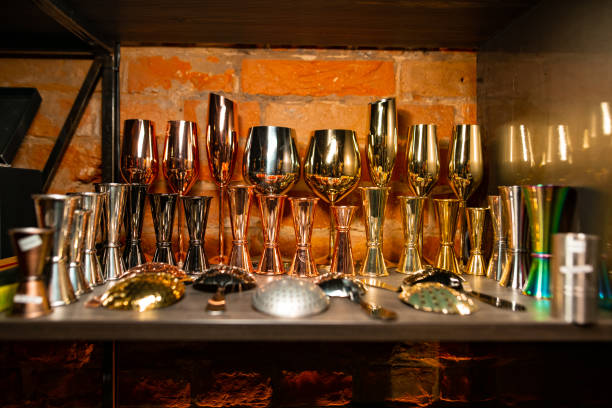 istock Bartender equipment as different metal color jiggers, glasses and strainer spoon 1206098341