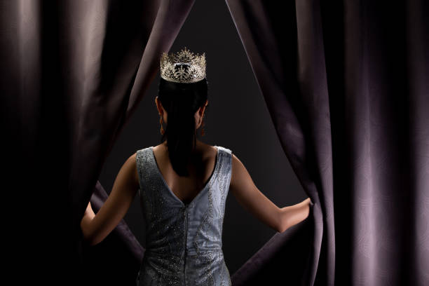 Miss Pageant Beauty Contest wears sequin Evening Gown long dress with sparkle Diamond Crown, Asian Woman opens purple Curtain after win Final round as new way life, opportunity, change everything