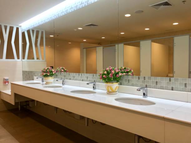 Row of wash sink with big mirror in public toilet stock photo
