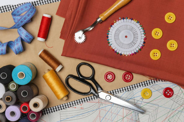 istock Set of different sewing items - top view of scissors, threads,buttons, sewing needles, fabric and patterns 1206112136