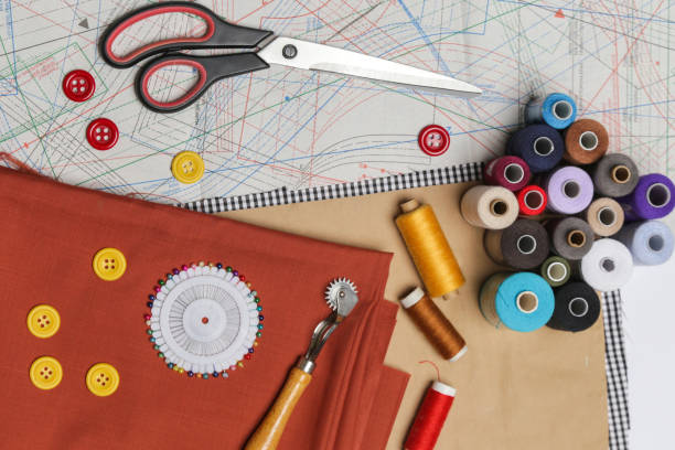 istock Set of different sewing items - top view of scissors, threads,buttons, sewing needles, fabric and patterns 1206112240
