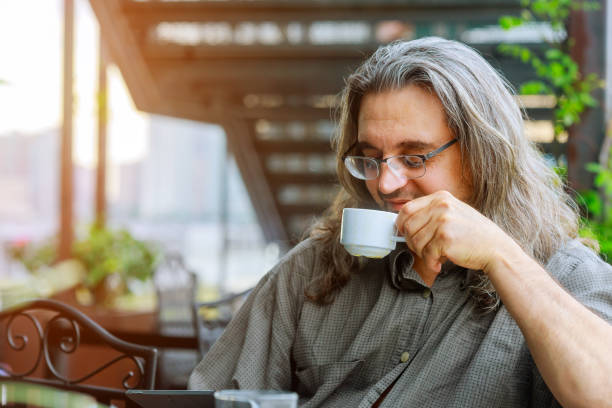 istock Men sitting in the at drinking coffee and using laptop 1206113519