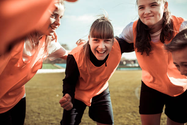 Huddling Close up of a female soccer team huddling before a game club soccer photos stock pictures, royalty-free photos & images