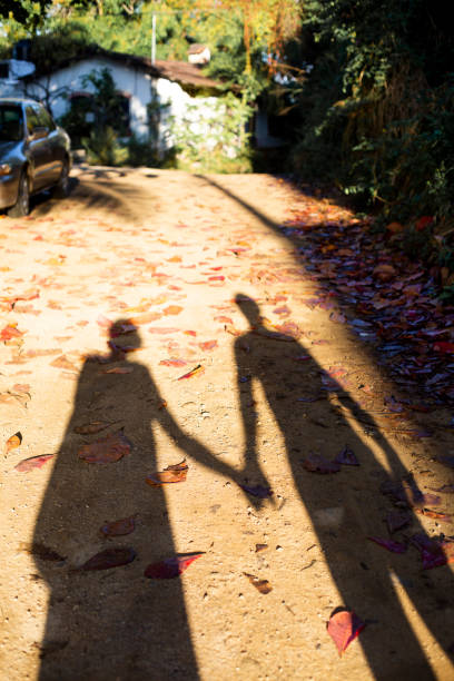 istock Shadow of a couple holding hands 1206115914