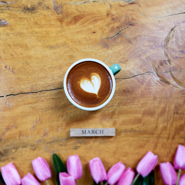 istock flat lay. coffee mug heart shape with tulip bouquet on wooden table 1206115944