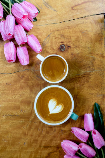 istock flat lay. coffee mug heart shape with tulip bouquet on wooden table 1206115946