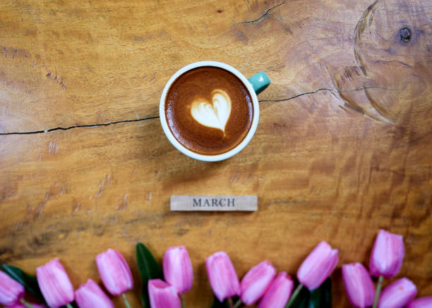 istock flat lay. coffee mug heart shape with tulip bouquet on wooden table 1206115947