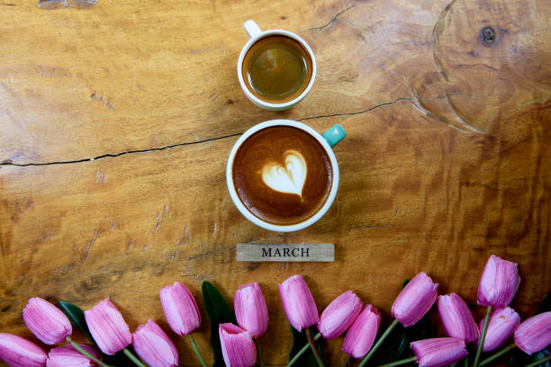 istock flat lay. coffee mug heart shape with tulip bouquet on wooden table 1206115953
